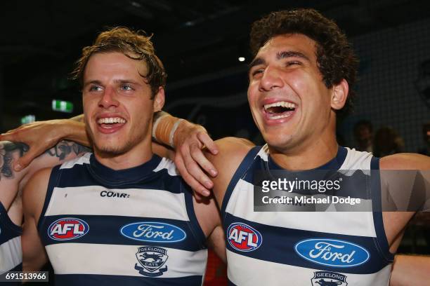 Jake Kolodjashnij of the Cats and Nakia Cockatoo of the Cats sing the club song after winning during the round 11 AFL match between the Geelong Cats...