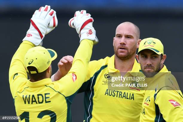 Australia's John Hastings celebrates dismissing New Zealand's Luke Ronchi for 65 runs during the ICC Champions trophy cricket match between Australia...