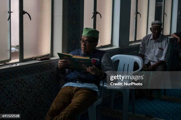 Man recite the Holy Quran in a Mosque during the Holy month of ramadan at Malaysia , Ramadan the Holiest month on Islamic calendar , Muslims refrain...