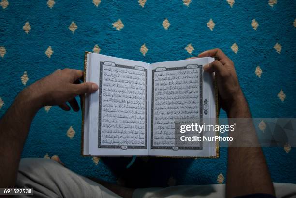 Man recite the Holy Quran in a Mosque during the Holy month of ramadan at Malaysia , Ramadan the Holiest month on Islamic calendar , Muslims refrain...