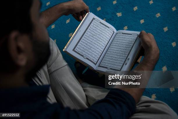 Man recite the Holy Quran in a Mosque during the Holy month of ramadan at Malaysia , Ramadan the Holiest month on Islamic calendar , Muslims refrain...