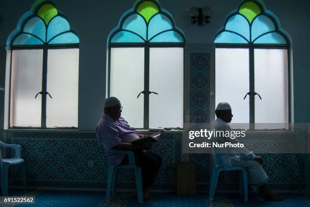 Man recite the Holy Quran in a Mosque during the Holy month of ramadan at Malaysia , Ramadan the Holiest month on Islamic calendar , Muslims refrain...