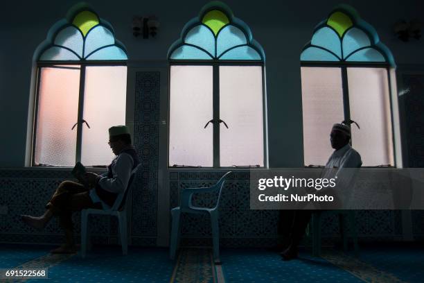 Man recite the Holy Quran in a Mosque during the Holy month of ramadan at Malaysia , Ramadan the Holiest month on Islamic calendar , Muslims refrain...