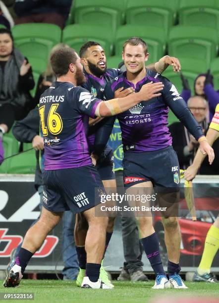 Cheyse Blair of the Storm is congratulated by Kenneath Bromwich and Josh Addo-Carr after scoring a try during the round 13 NRL match between the...