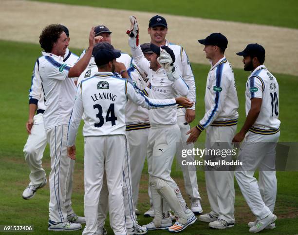 Ryan Sidebottom of Yorkshire celebrates taking the wicket of Alex Davies of Lancashire with teamates during Day One of the Specsavers County...