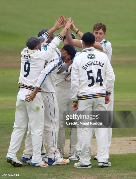 Ben Coad of Yorkshire celebrates with teamates after taking the wicket of Steven Croft of Lancashire during Day One of the Specsavers County...