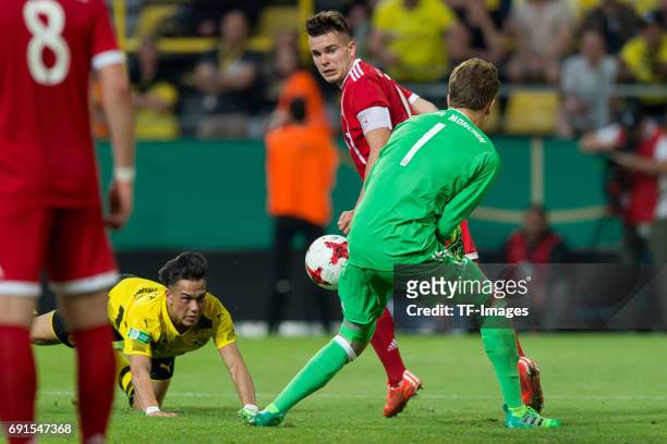 Hueseyin Bulut of Dortmund , Matthias Stingl of Munich and Goalkeeper Ron Thorben Hoffmann of Munich battle for the ball during the U19 German...