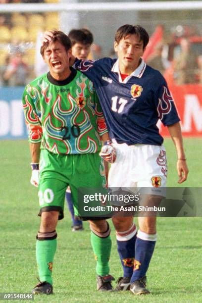 Yoshikatsu Kawaguchi of Japan is consoled by Yutaka Akita after the 1-1 draw during the France World Cup Asian Final Qualifier match between...