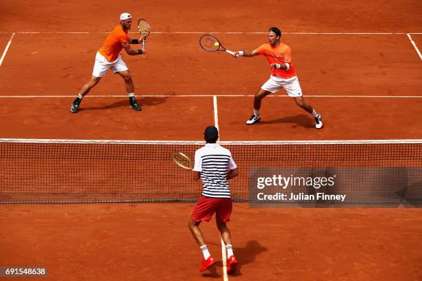 Sam Groth of Australia and partner Robert Lindstedt of Sweden return the ball during mens doubles second round match against Bob Bryan and Mike Bryon...