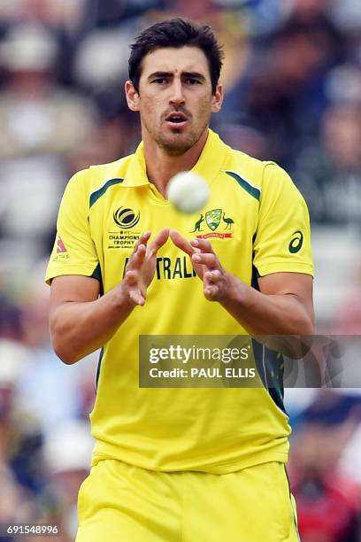 Australia's Mitchell Starc receives the ball while bowling during the ICC Champions trophy cricket match between Australia and New Zealand at...