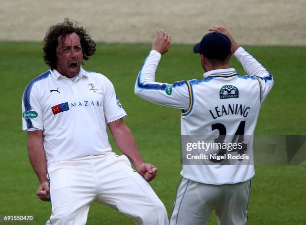 Ryan Sidebottom of Yorkshire celebrates with Jack Leaning after taking the wicket of Luke Proctor of Lancashire during Day One of the Specsavers...