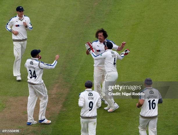 Ryan Sidebottom of Yorkshire celebrates with teamates after taking the wicket of Ryan McLaren of Lancashire during Day One of the Specsavers County...