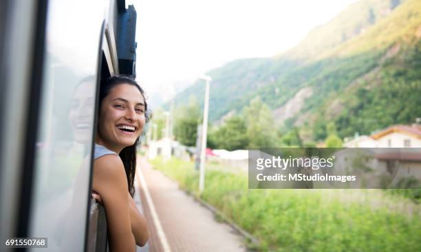 Smiling woman looking at the view from train.