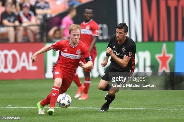 Dax McCarty of Chicago Fire dribbles by Sebastien Le Toux of D.C. United during a MLS Soccer game at RFK Stadium on May 20, 2017 in Washington, DC....
