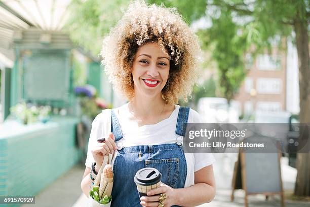 portrait of content woman in urban environment - bleached hair stock-fotos und bilder