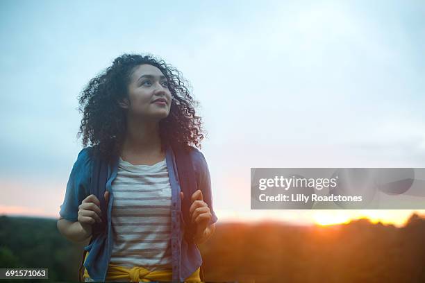 young woman hiking at dawn - hiking rucksack stock pictures, royalty-free photos & images