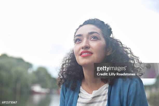 young woman looking up into the sky - intuition stock pictures, royalty-free photos & images