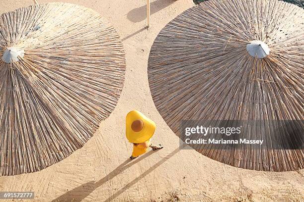 a fashionable woman walks along the beach - greek woman stock-fotos und bilder