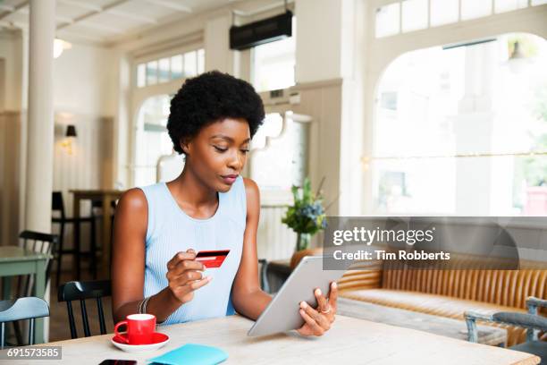 woman with credit card and tablet - internet café stock-fotos und bilder