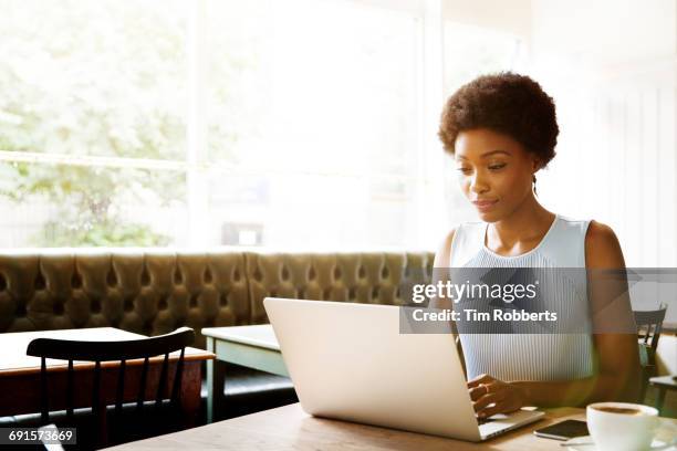 woman using laptop in cafe. - different types of chairs stock pictures, royalty-free photos & images