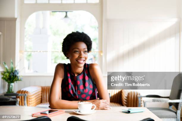 woman relaxing with coffee - black cup saucer stock pictures, royalty-free photos & images