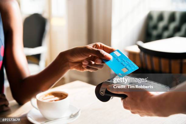 woman using contactless payment, close up - クレジットカードリーダ ストックフォトと画像