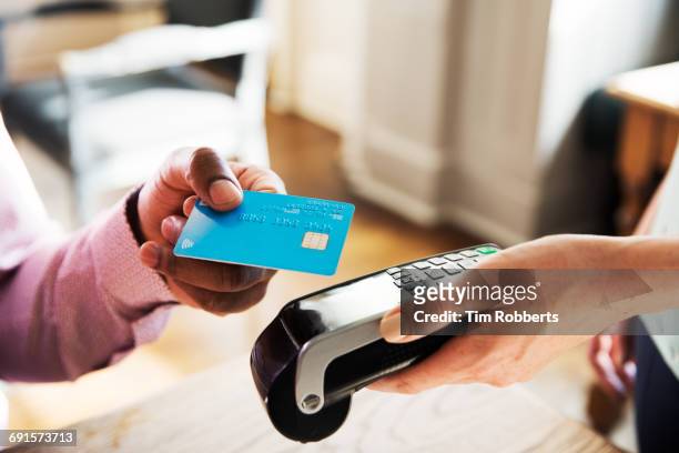 man using contactless payment, close up - クレジットカードリーダ ストックフォトと画像