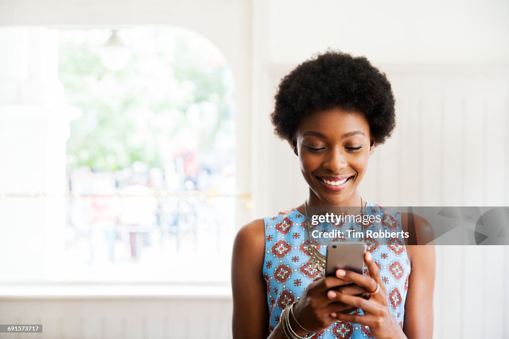 Woman smiling using smart phone