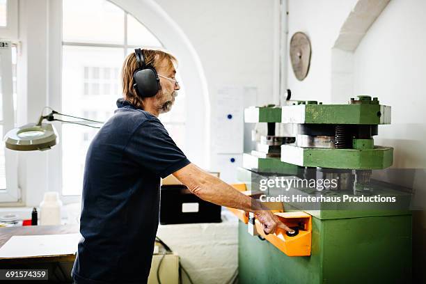 worker on a punch - ponspers stockfoto's en -beelden