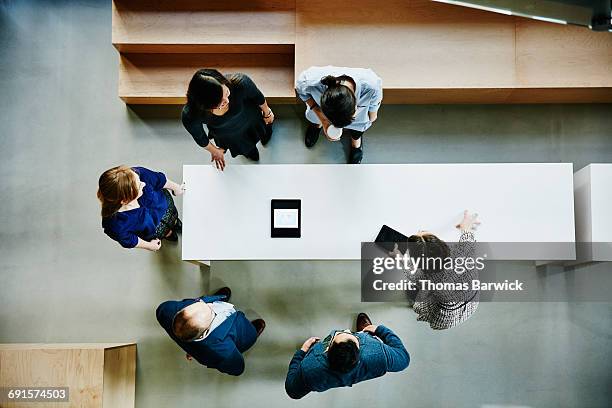 overhead view of businesswoman leading meeting - knowledge sharing business stock pictures, royalty-free photos & images