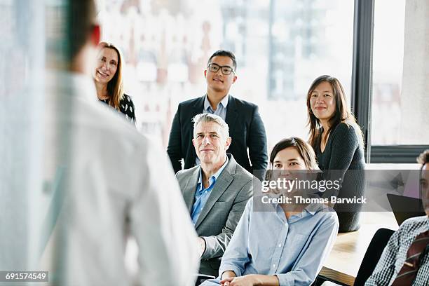 businesspeople listening to project presentation - wisdom stock pictures, royalty-free photos & images