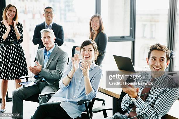 coworkers applauding after presentation in office - business clapping hands stock pictures, royalty-free photos & images