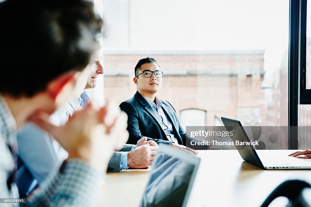 Businessman listening during meeting in office