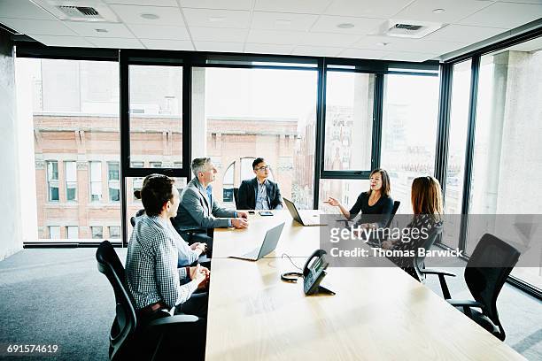 businesswoman leading project meeting in office - public scrutiny stock pictures, royalty-free photos & images