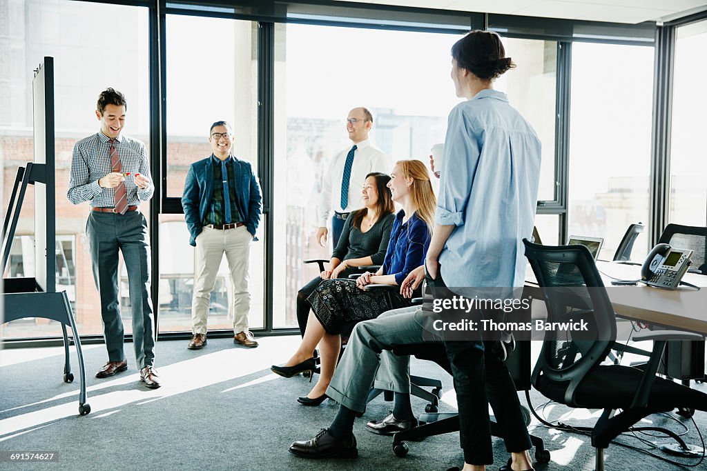 Laughing businessman leading team meeting