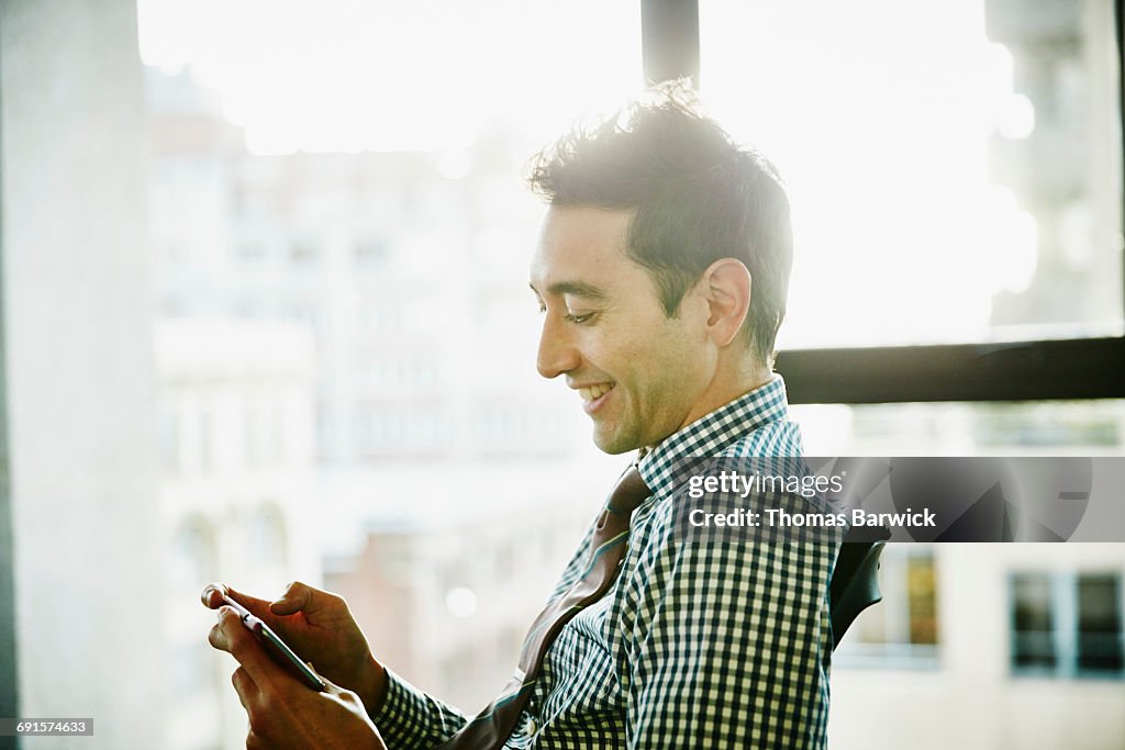 Businessman working on smartphone in office