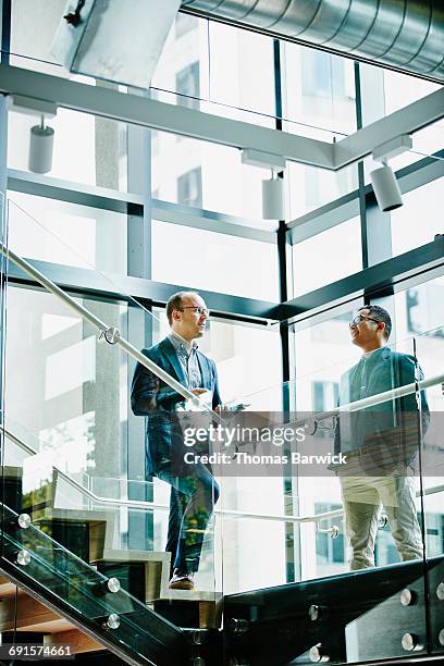 businessmen in discussion on office stairs - 2 steps stock pictures, royalty-free photos & images