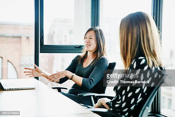 businesswoman leading discussion during meeting - woman making a deal stock pictures, royalty-free photos & images