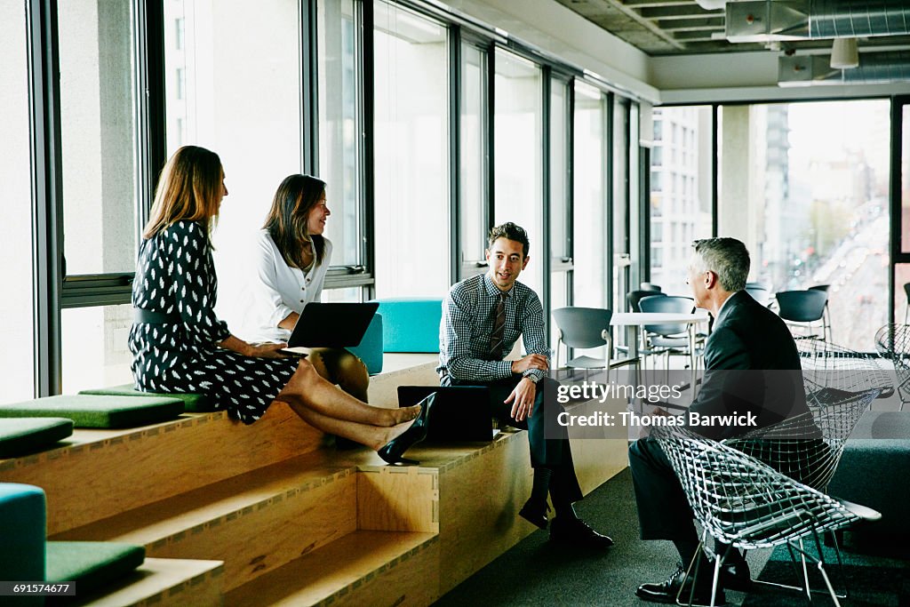 Colleagues having informal meeting in office
