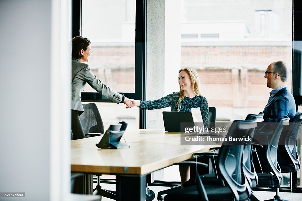 Businesswomen shaking hands after meeting