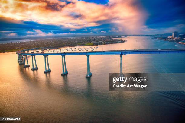 coronado bridge during a stormy dramatic sunset - coronado island stock pictures, royalty-free photos & images