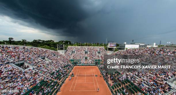 Photo shows an overall view of the Suzanne Lenglen court with the Eiffel Tower in the background during the tennis match between France's Kristina...