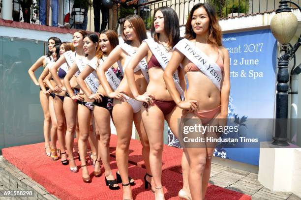 Contestants of the Miss Tibet Beauty Pageant pose during the swimwear round at the Miss Tibet Beauty Pageant 2017 at Naddi, Mcleodganj on June 2,...