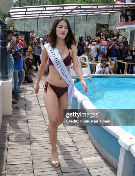 Contestants of the Miss Tibet Beauty Pageant pose during the swimwear round at the Miss Tibet Beauty Pageant 2017 at Naddi, Mcleodganj on June 2,...
