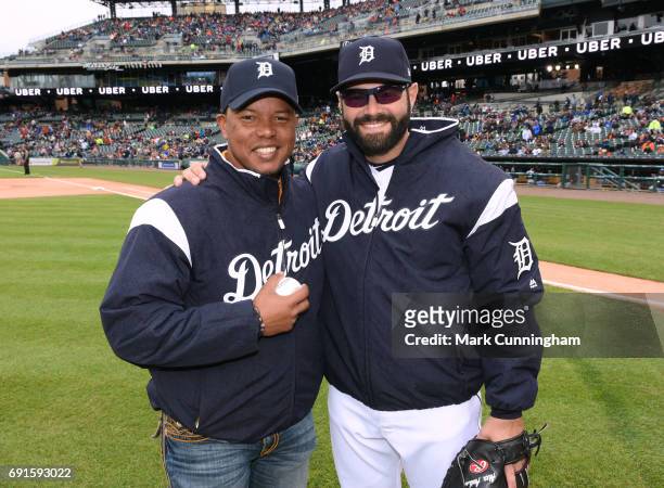Former Detroit Tigers infielder Ramon Santiago poses for a photo with Alex Avila of the Detroit Tigers prior to the game against the Chicago White...