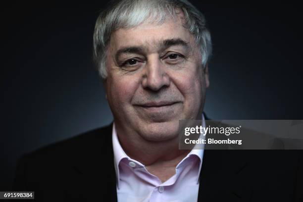 Mikhail Gutseriev, chairman of RussNeft OAO, poses for a photograph during the St. Petersburg International Economic Forum at the Expoforum in Saint...