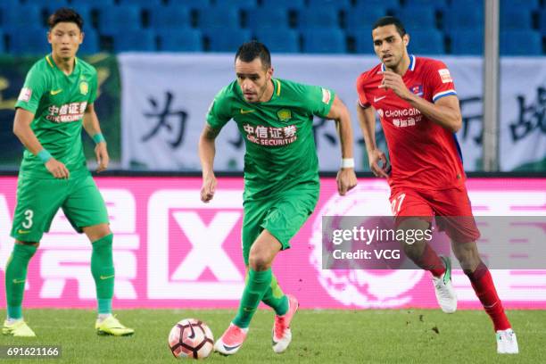 Alan Kardec of Chongqing Lifan and Renato Augusto of Beijing Guoan compete for the ball during the 12th round match of 2017 Chinese Football...