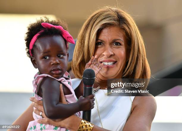 Today" Show host Hoda Kotb holds Thomas Rhett's daughter Willa Gray during Thomas Rhett's performance on NBC's "Today" at Rockefeller Plaza on June...