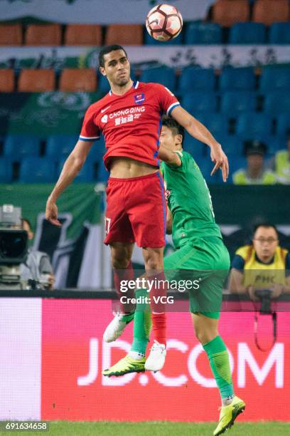 Alan Kardec of Chongqing Lifan jumps to head the ball during the 12th round match of 2017 Chinese Football Association Super League between Chongqing...