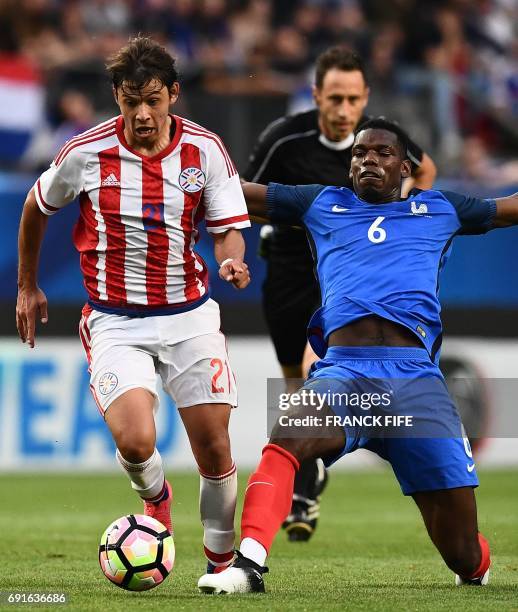 Paraguay's forward Oscar Romero vies with France's midfielder Paul Pogba during a friendly football match between France and Paraguay on June 2 at...